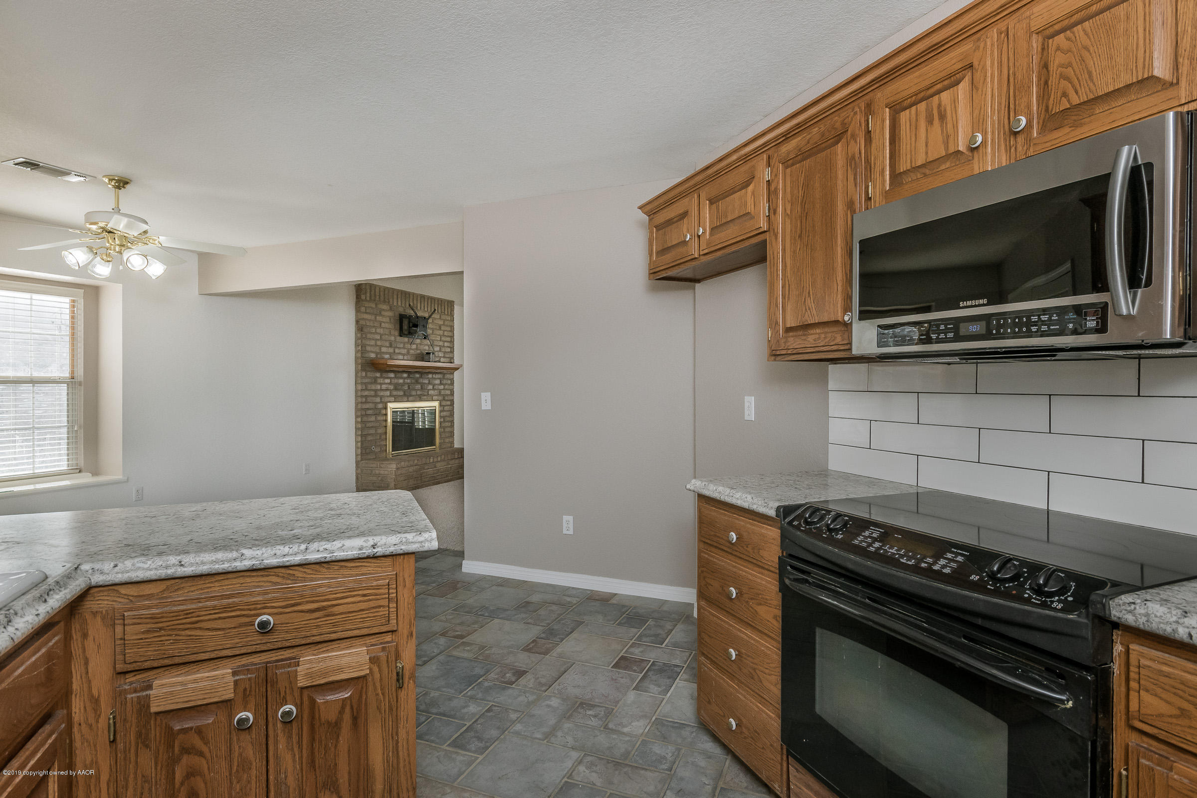 5404 Leo Lane Amarillo, TX 79110 - Photo 7 of 20 a kitchen with a stove and a microwave