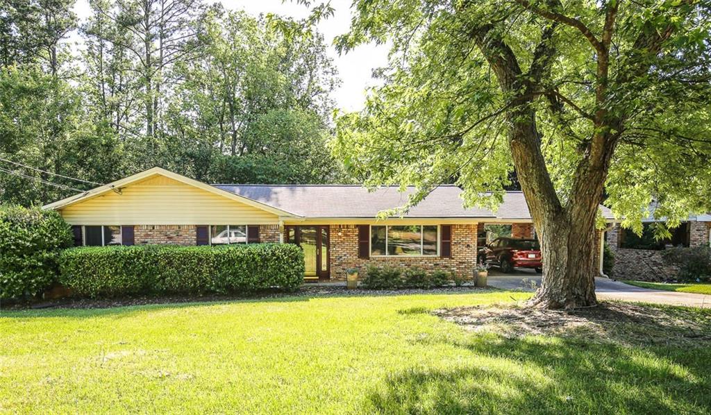 1318 Weston Drive Decatur, GA 30032 - Photo 1 of 1 a front view of a house with a yard and trees