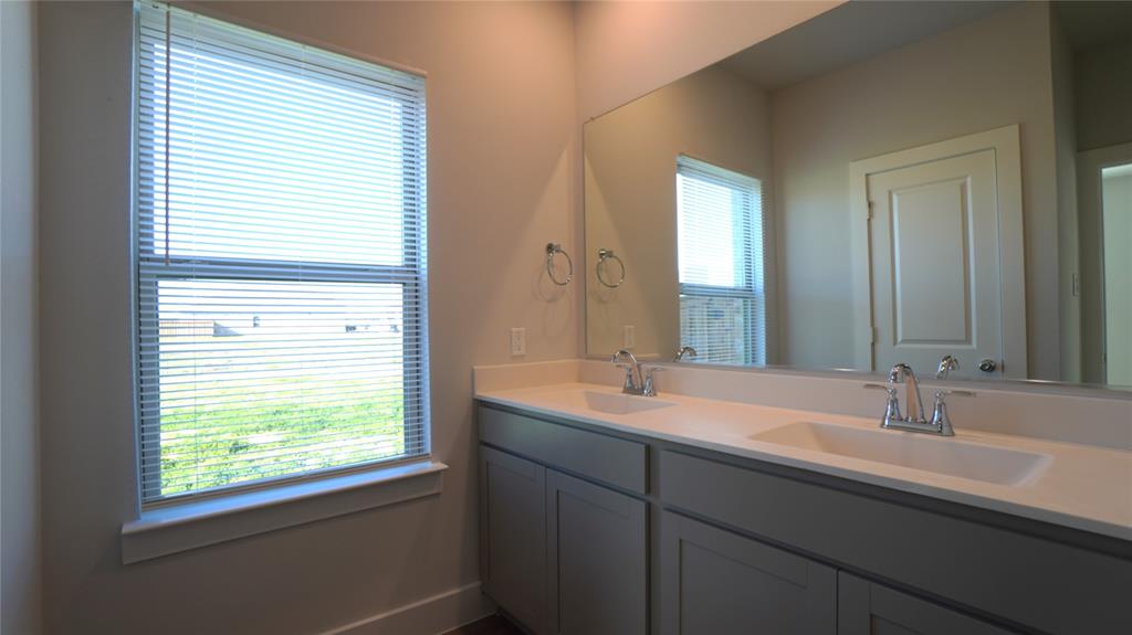 1374 Chisos Way Forney, TX 75126 - Photo 15 of 25 a bathroom with a double vanity sink and mirror