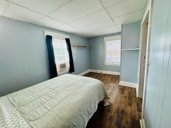 a bedroom with a bed and a window