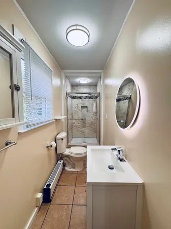 a bathroom with a toilet sink and mirror