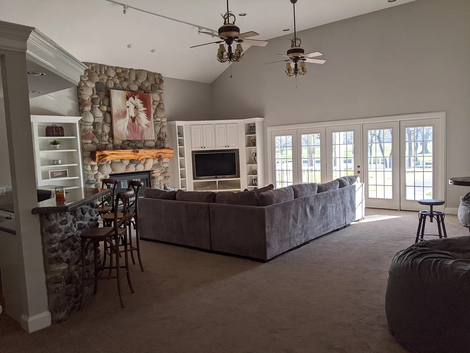 4309 Bowser Road Fulshear, TX 77441 - Photo 12 of 21 a living room with furniture a flat screen tv and a fireplace