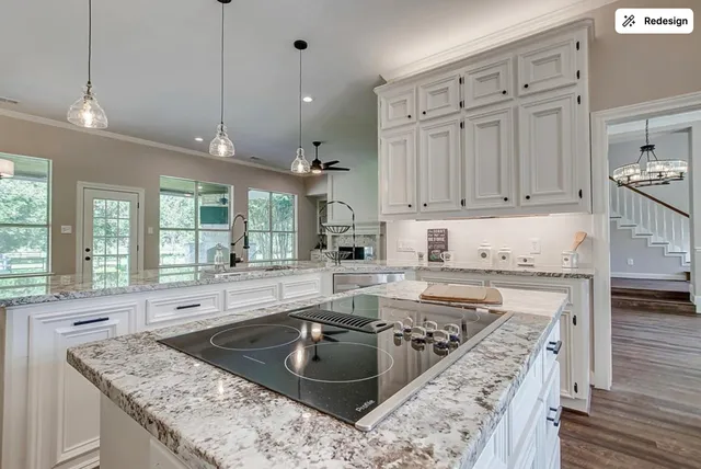 a kitchen with stainless steel appliances granite countertop a sink stove and cabinets