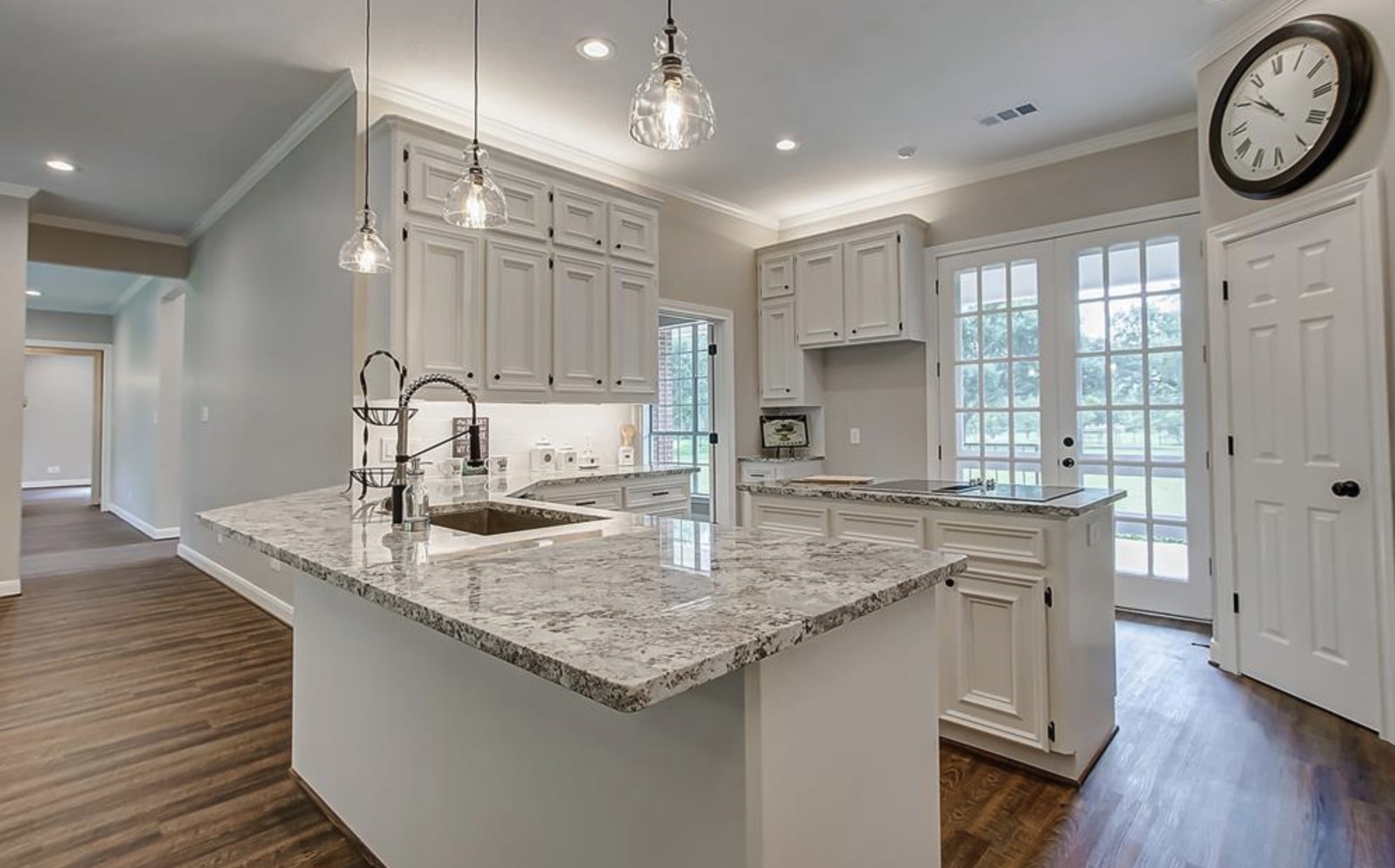 4309 Bowser Road Fulshear, TX 77441 - Photo 14 of 21 a kitchen with kitchen island granite countertop a sink cabinets and wooden floor