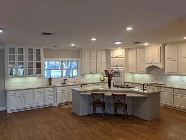 a kitchen with stainless steel appliances granite countertop wooden cabinets and sink