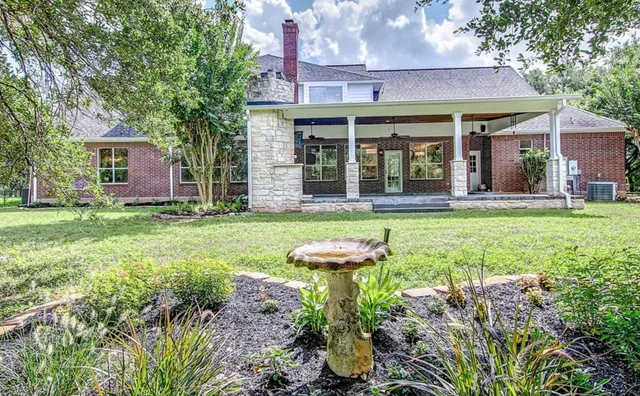 front view of a brick house with a yard