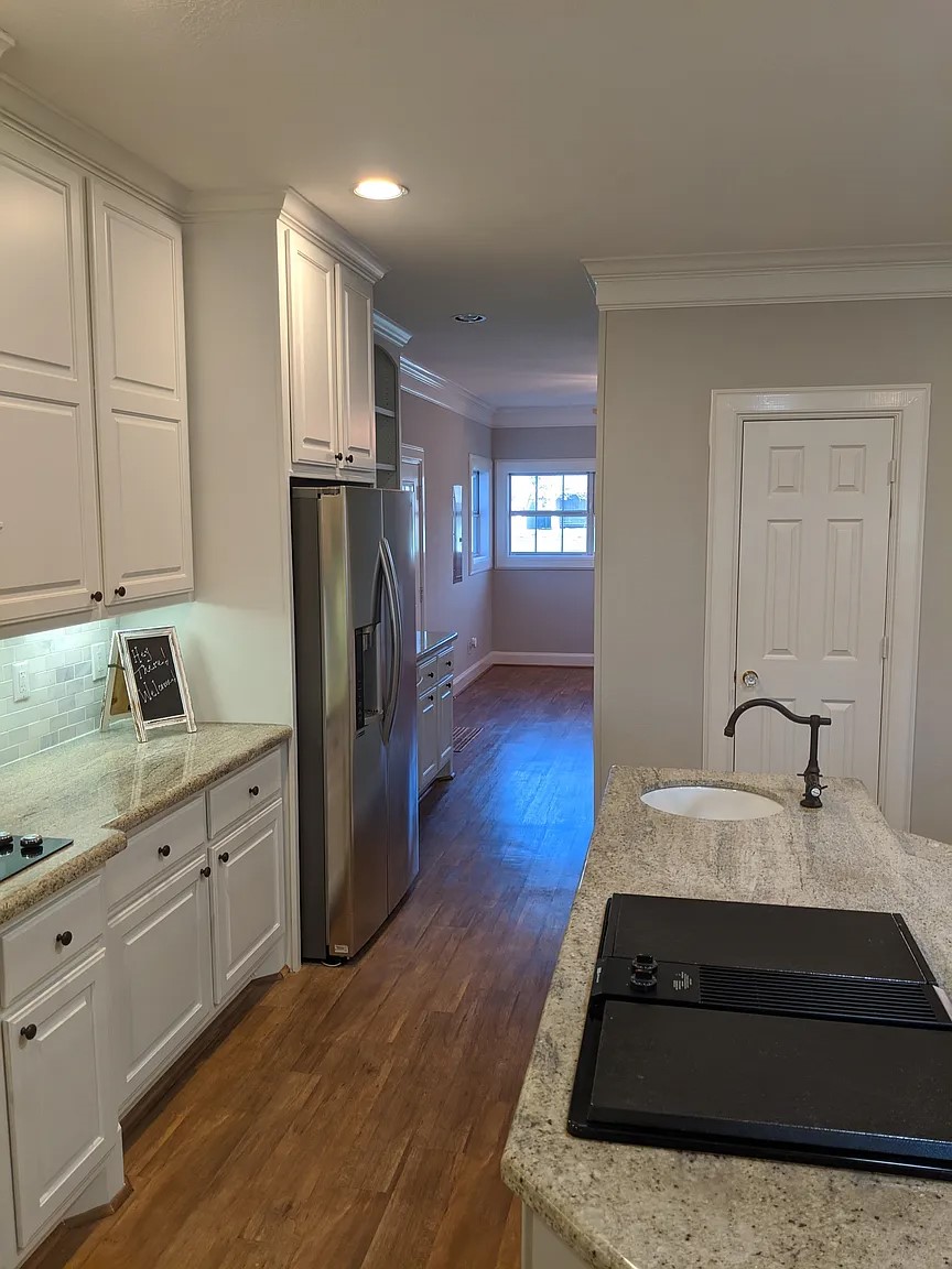 4309 Bowser Road Fulshear, TX 77441 - Photo 18 of 21 a kitchen with a refrigerator and a sink