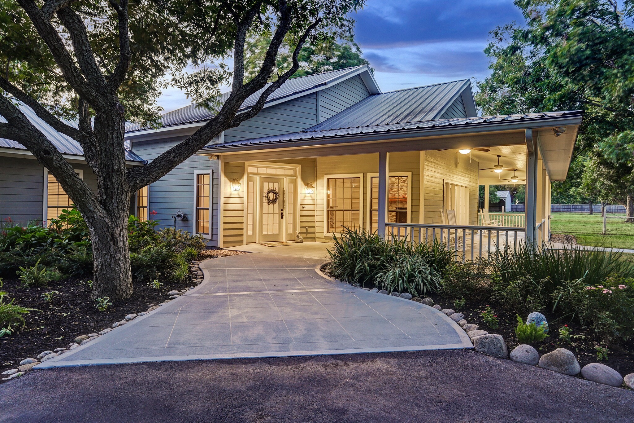 4309 Bowser Road Fulshear, TX 77441 - Photo 8 of 21 a view of a house with brick walls plants and large tree