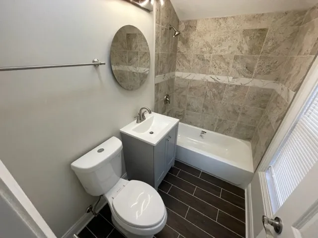 a bathroom with a toilet a sink and a shower