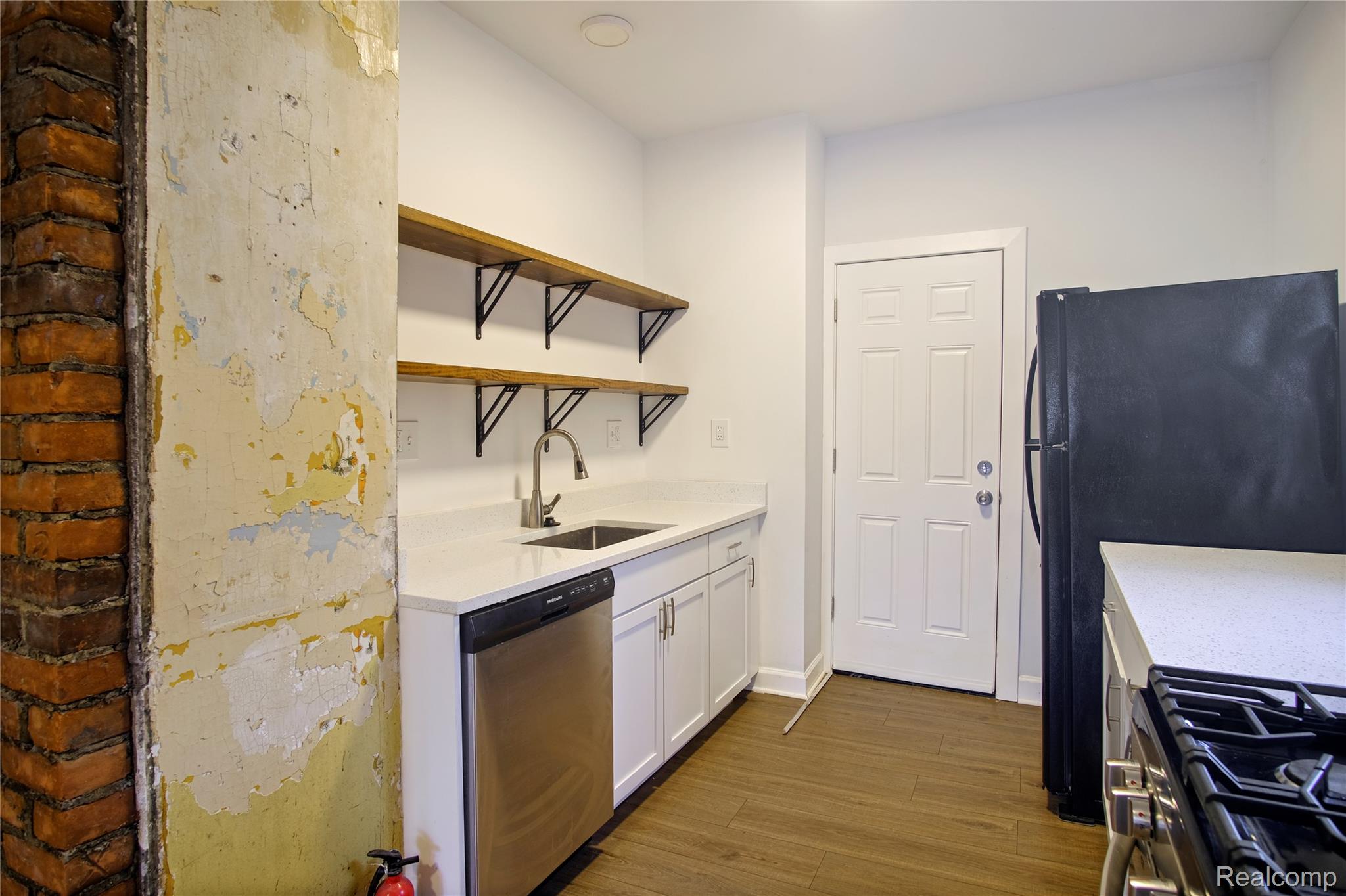 6123 Commonwealth Street Detroit, MI 48208 - Photo 3 of 14 Kitchen with open shelves, stainless steel appliances, white cabinetry, dark wood finished floors, and light stone countertops