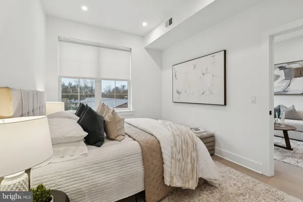 a bedroom with a bed and wooden floor