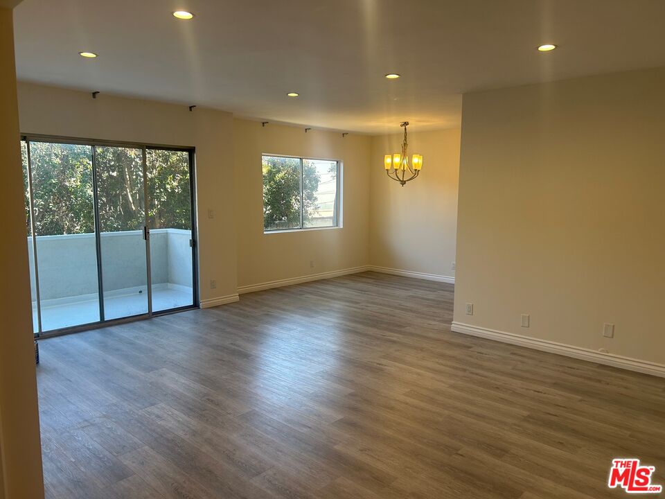 1440 Reeves Street, Unit 105 Los Angeles, CA 90035 - Photo 2 of 9 an empty room with wooden floor and a window