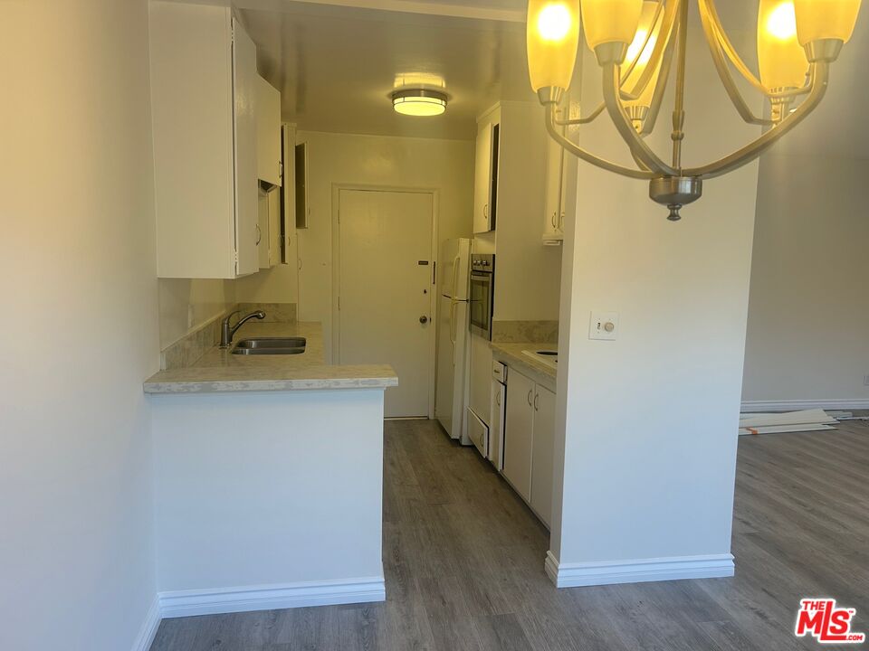 1440 Reeves Street, Unit 105 Los Angeles, CA 90035 - Photo 6 of 9 a bathroom with a sink a mirror and shower