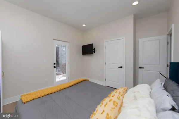 a bedroom with a bed and window