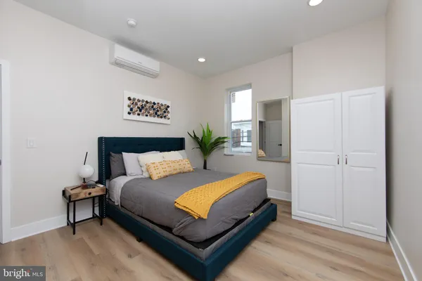 a bedroom with a bed and a television