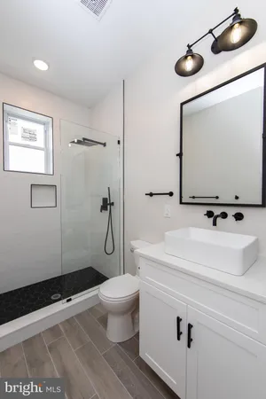 a bathroom with a sink toilet and shower