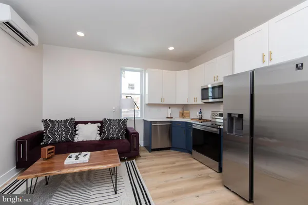 a kitchen with a refrigerator and a stove