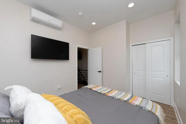 a bedroom with a bed and a flat screen tv