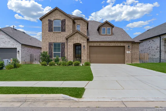 a front view of a house with a yard and garage