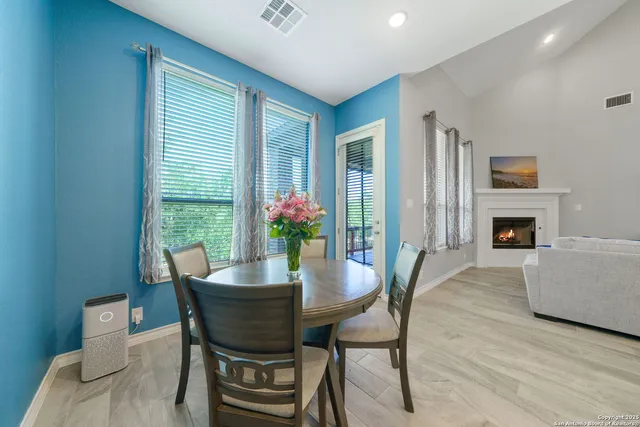 a dining room with furniture and wooden floor
