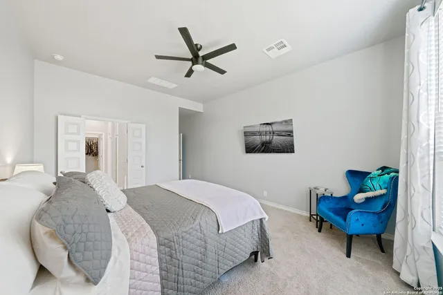 a spacious bedroom with a bed and a window