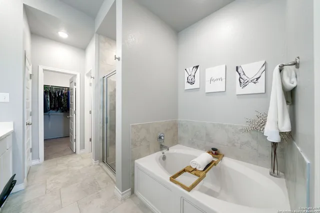 a bathroom with a tub sink and shower