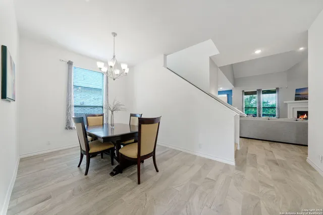 a view of a dining room with furniture and a chandelier