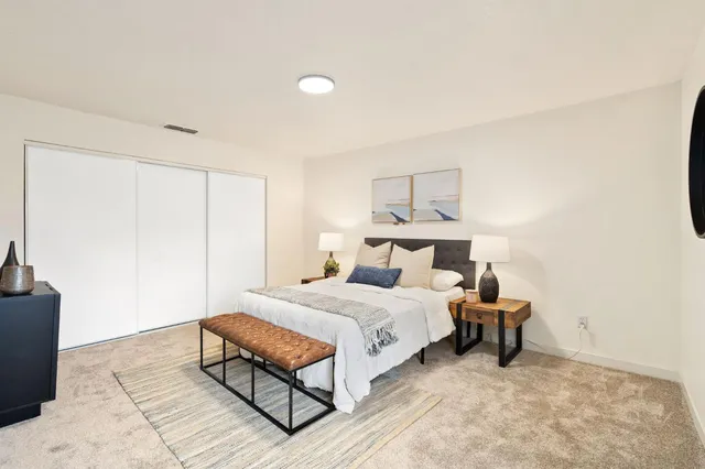 a bedroom with a bed and a couch