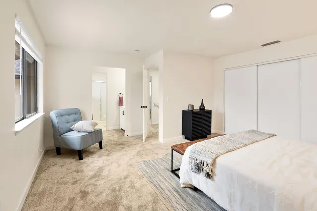 a bedroom with a bed and a couch