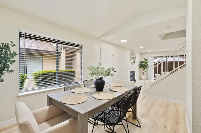 a dining room with furniture and window
