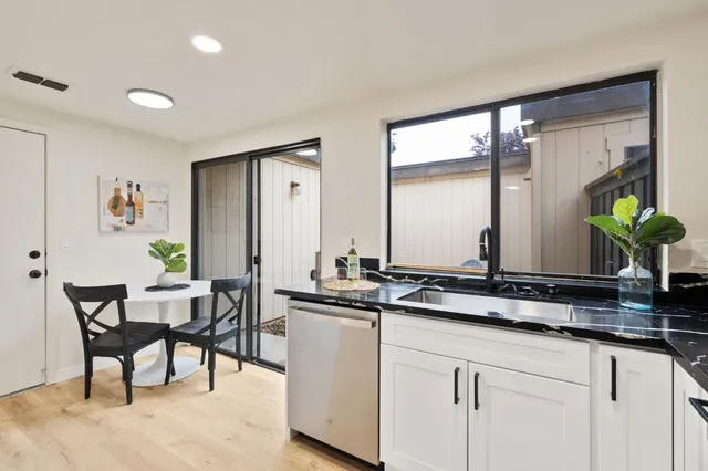 a view of kitchen island sink and living room