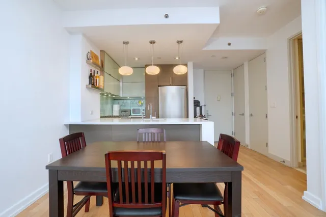 a view of a dining room with furniture and wooden floor