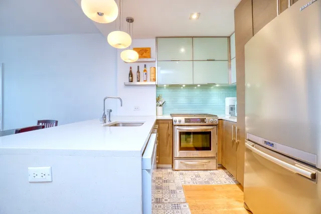 a kitchen with a sink cabinets and wooden floor