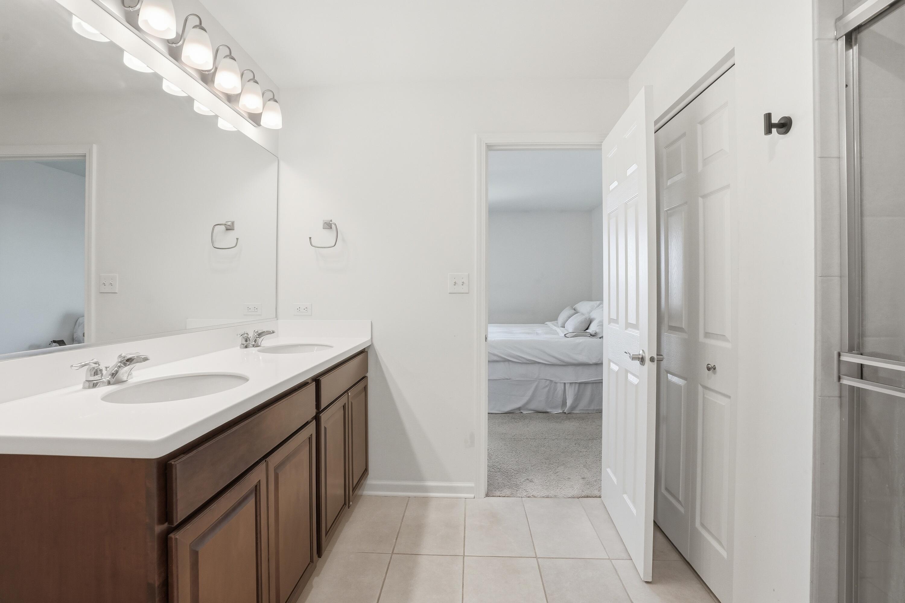 10322 Adler Cove St. John, IN 46373 - Photo 19 of 26 a spacious bathroom with a double vanity sink and a mirror