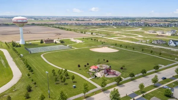 an aerial view of a house yard swimming pool and outdoor seating