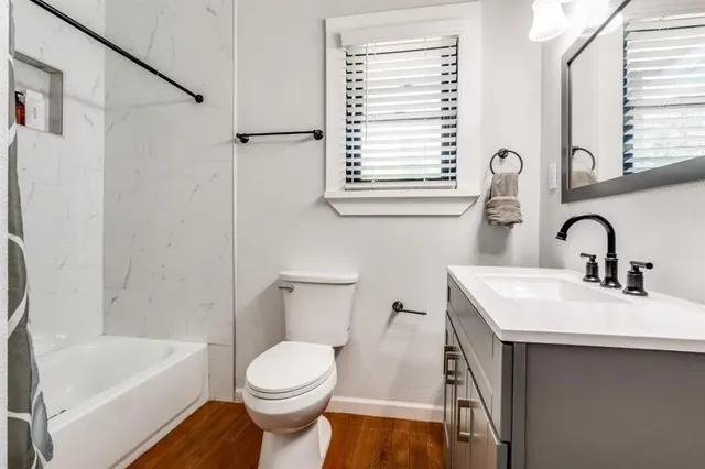 a bathroom with a sink toilet and shower