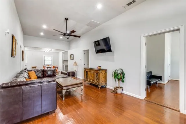 a living room with fireplace furniture and a flat screen tv