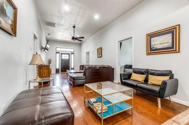 a living room with furniture a rug and a chandelier