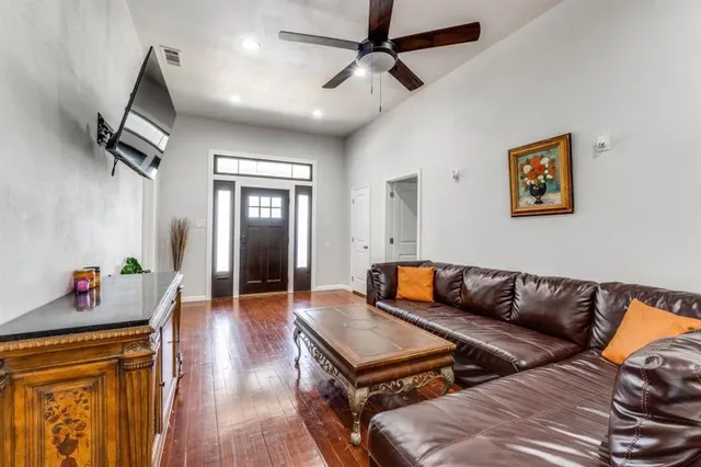 a living room with furniture and wooden floor