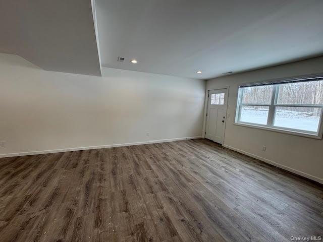 11 Alexandra Matthews Road, Unit B Wallkill, NY 12589 - Photo 14 of 41 an empty room with wooden floor and windows