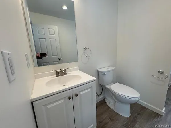 a bathroom with a toilet sink and mirror