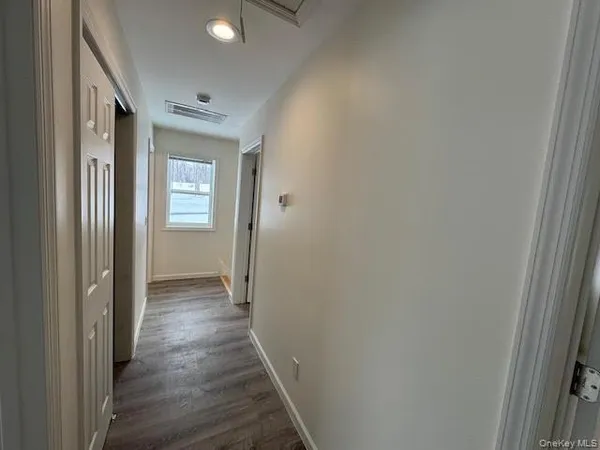 a view of hallway with wooden floor