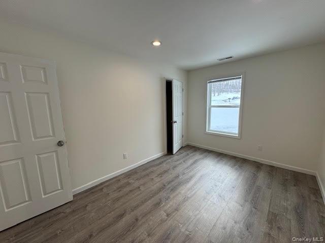 11 Alexandra Matthews Road, Unit B Wallkill, NY 12589 - Photo 21 of 41 an empty room with wooden floor and window