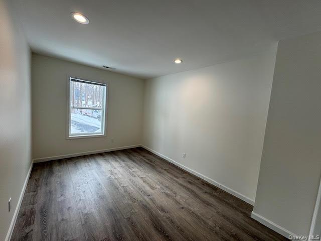 11 Alexandra Matthews Road, Unit B Wallkill, NY 12589 - Photo 22 of 41 an empty room with wooden floor and windows