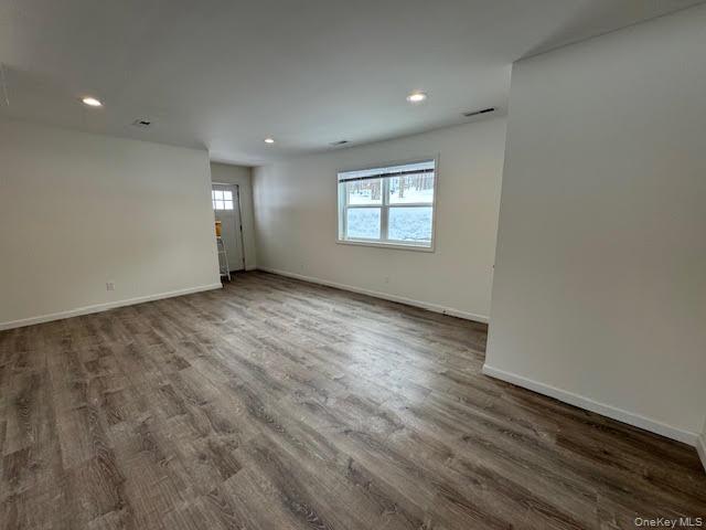 11 Alexandra Matthews Road, Unit B Wallkill, NY 12589 - Photo 5 of 41 an empty room with wooden floor and windows