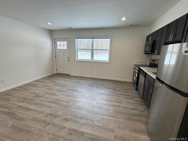 11 Alexandra Matthews Road, Unit B Wallkill, NY 12589 - Photo 7 of 41 wooden floor in an empty room with a window