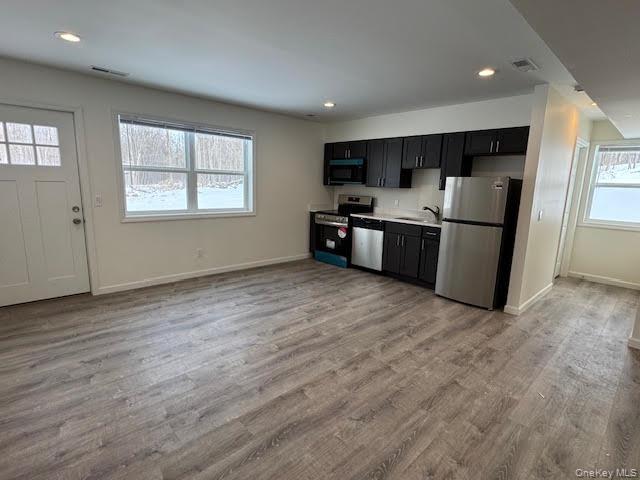 11 Alexandra Matthews Road, Unit B Wallkill, NY 12589 - Photo 8 of 41 a large kitchen with stainless steel appliances granite countertop a refrigerator a sink dishwasher a stove and a refrigerator with wooden floor