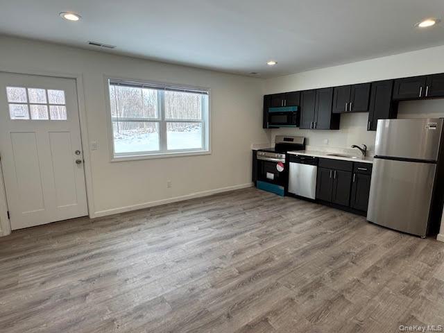 11 Alexandra Matthews Road, Unit B Wallkill, NY 12589 - Photo 9 of 41 a kitchen with stainless steel appliances granite countertop a refrigerator stove a sink dishwasher and a microwave oven with wooden floor