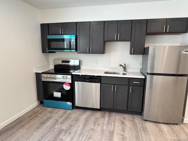 11 Alexandra Matthews Road, Unit B Wallkill, NY 12589 - Photo 10 of 41 a kitchen with stainless steel appliances a refrigerator stove and microwave