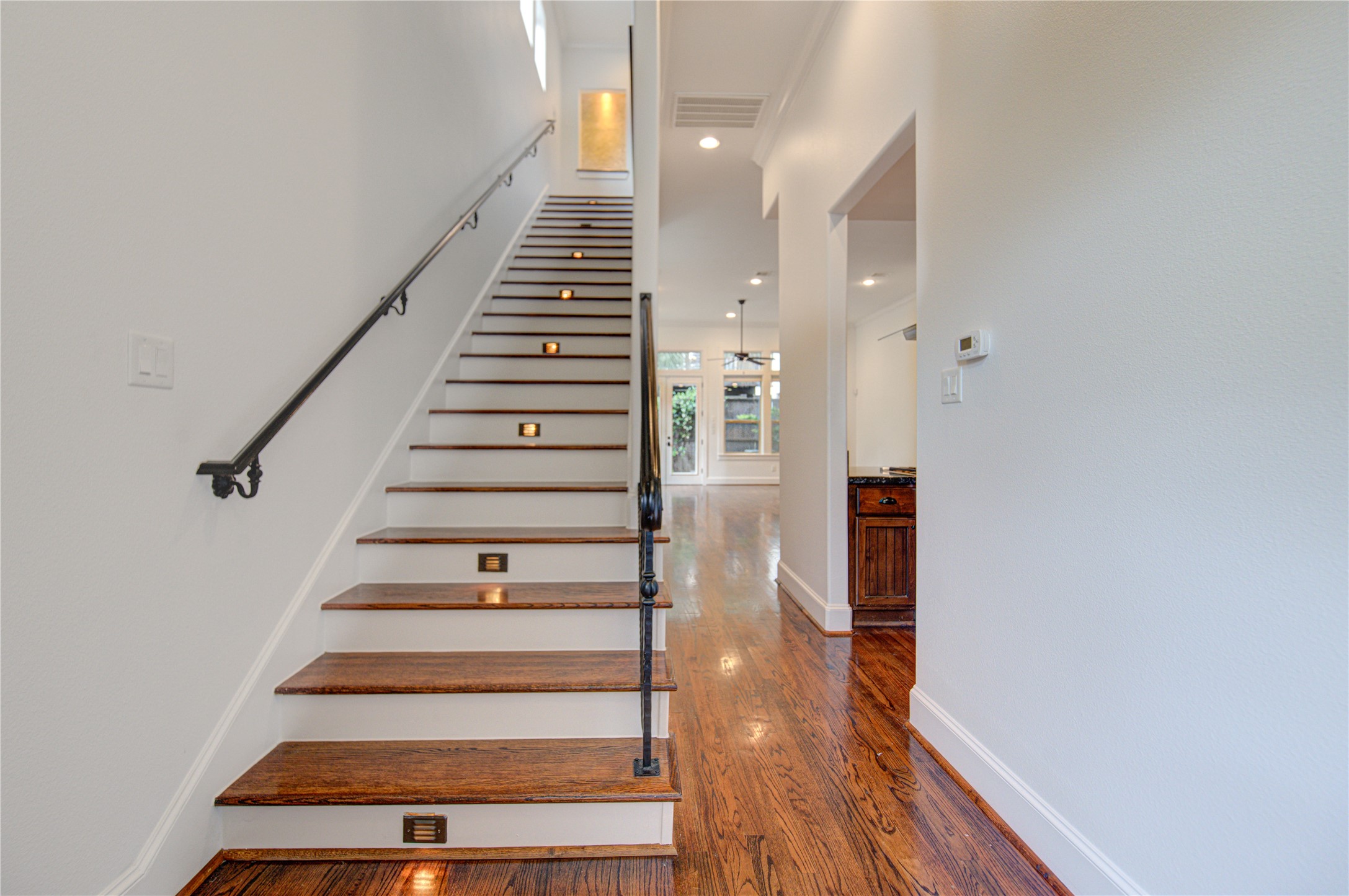 6520 Rodrigo Street Houston, TX 77007 - Photo 15 of 44 Staircase with hardwood treads, iron railing, and integrated step lighting leading to the upper level